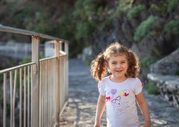 Portrait of cute girl standing outdoors