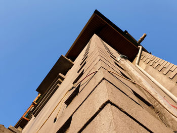 Low angle view of building against clear blue sky