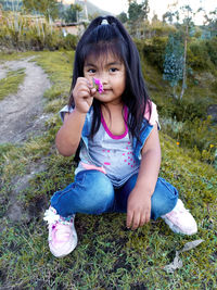 Portrait of a girl sitting on field