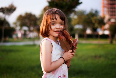 Portrait of smiling girl standing outdoors