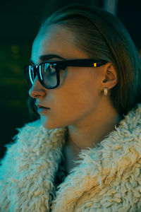 Close-up portrait of young woman looking away