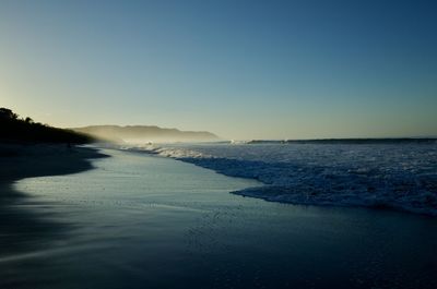 Scenic view of sea against clear sky during sunset