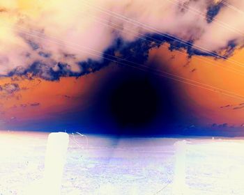 Low angle view of silhouette electricity pylon against sky