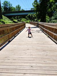 Full length of man walking on footbridge