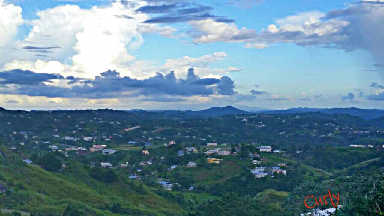 building exterior, sky, mountain, built structure, architecture, tree, high angle view, cloud - sky, landscape, cityscape, house, town, residential structure, residential district, cloud, residential building, mountain range, crowded, city, townscape