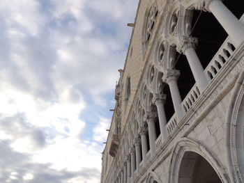 Low angle view of historical building against cloudy sky