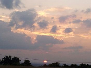 Scenic view of cloudy sky at sunset