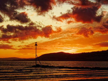 Scenic view of sea against orange sky