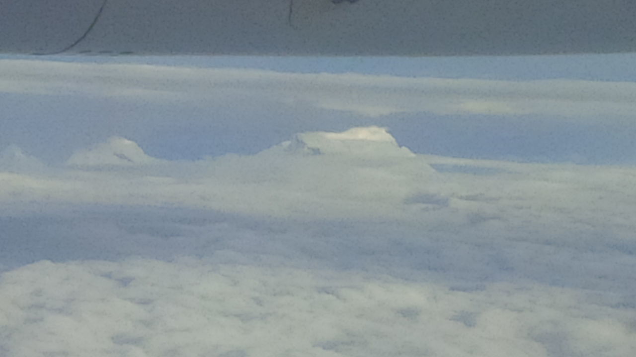 SCENIC VIEW OF CLOUDS OVER MOUNTAINS