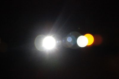 Low angle view of illuminated lights against sky
