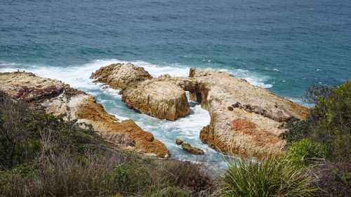 High angle view of rocks at sea shore