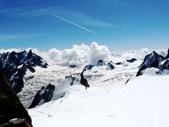 Scenic view of snow mountains against blue sky