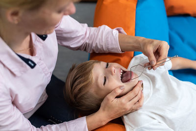 Midsection of doctor examining patient