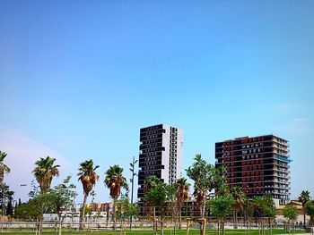 Low angle view of modern building against blue sky