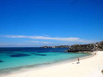 Scenic view of beach against blue sky