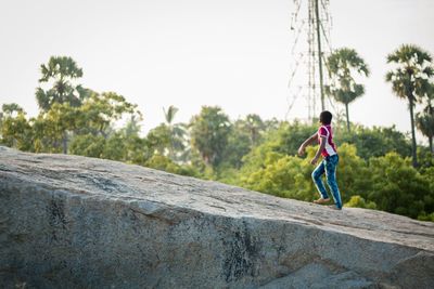 Children playing in park against clear sky