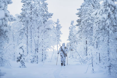 Hunters in winter forest