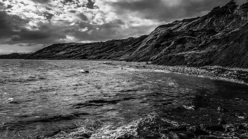 Scenic view of sea against storm clouds