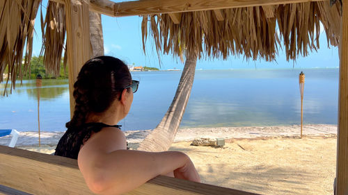 Portrait of young woman sitting at beach