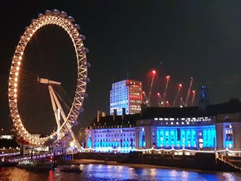 Illuminated ferris wheel at night