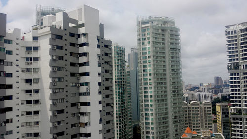 Low angle view of buildings in city against sky