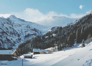 Scenic view of snow covered mountains against sky