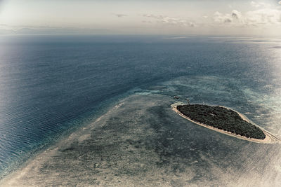 High angle view of sea shore against sky