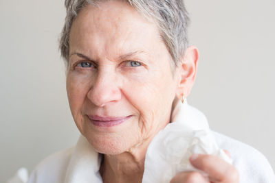 Portrait of smiling mid adult woman against white background