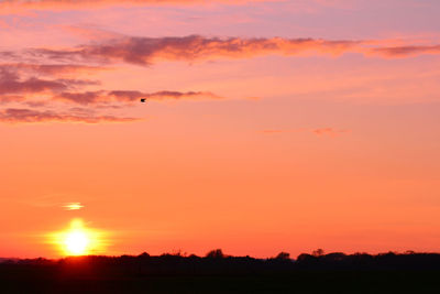 Scenic view of silhouette landscape against romantic sky at sunset