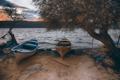 Boats moored on beach against sky