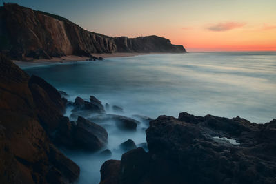 Scenic view of sea against sky at sunset