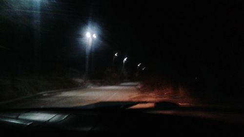 Close-up of car on road at night