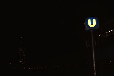 Illuminated road sign at night