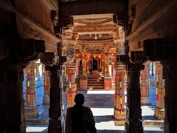 Rear view of man standing in temple