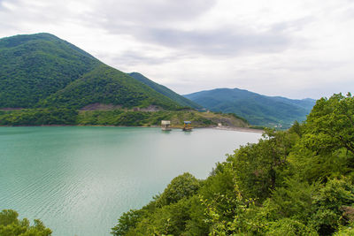 Scenic view of lake and mountains against sky