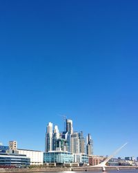 Modern cityscape against clear blue sky