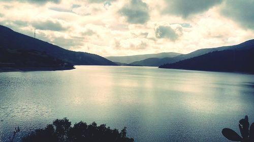 Scenic view of lake against cloudy sky