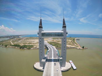 View of bridge over sea against cloudy sky