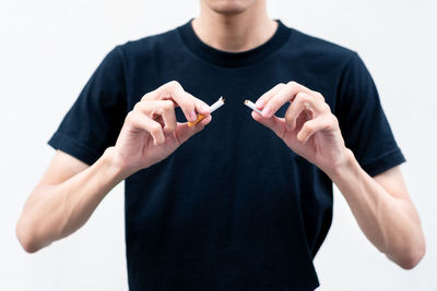 Midsection of person wearing mask against white background