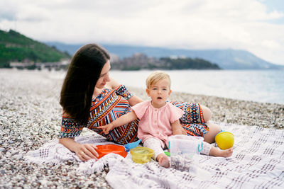 Friends sitting on shore