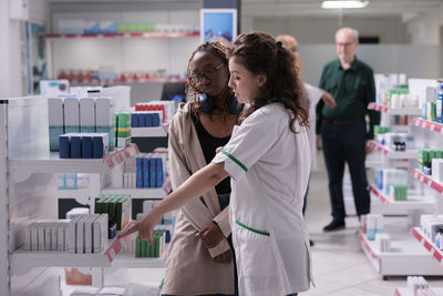 Side view of woman standing in store