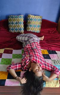 Woman lying down on bed at home