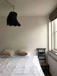 Lamp hanging over bed at home