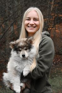 Portrait of smiling young woman with dog