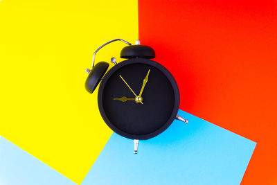 Low angle view of clock against wall