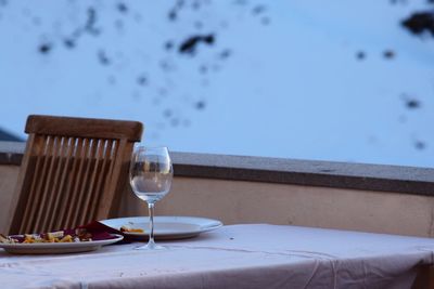 Close-up of wine on table against sea