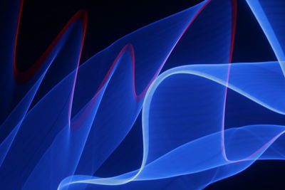 Close-up of light painting against black background