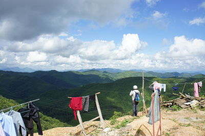 People on mountain against sky