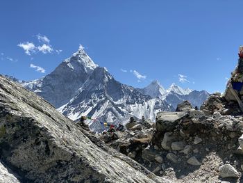 Scenic view of snowcapped mountains against clear blue sky