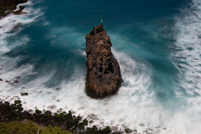 High angle view of rock formation in sea